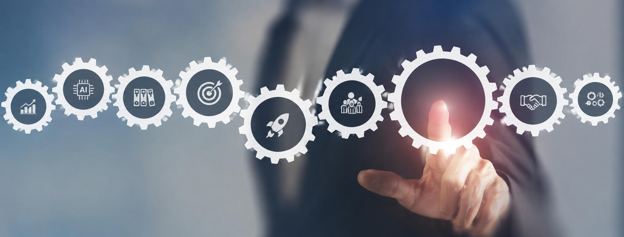 Businessman interacting with gear icons representing strategy and teamwork concepts